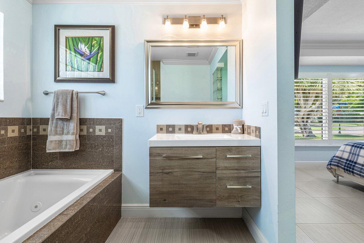 701 Buoy Road North Palm Beach, FL 33408 - Photo 25 of 52 a bathroom with a double vanity sink mirror and bathtub