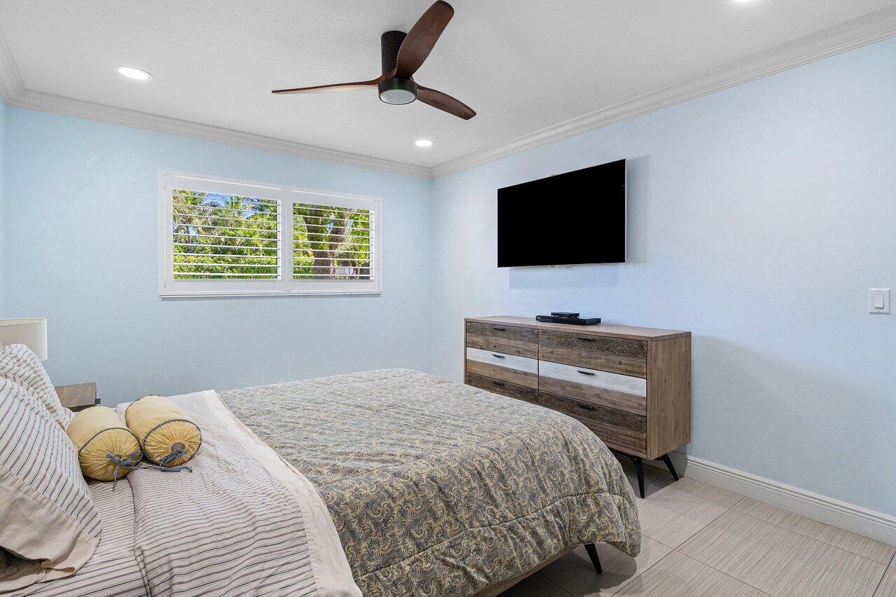 701 Buoy Road North Palm Beach, FL 33408 - Photo 32 of 52 a bedroom with a bed and a flat screen tv
