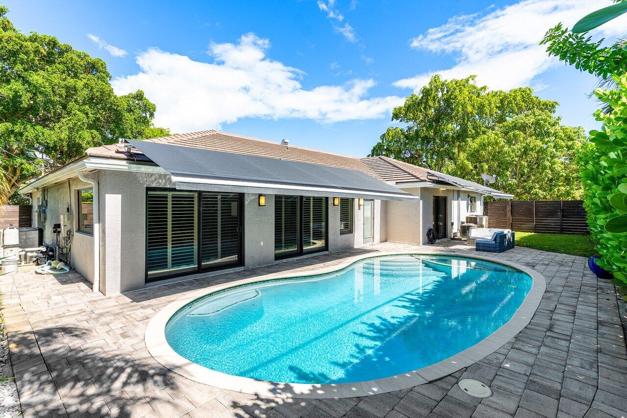 701 Buoy Road North Palm Beach, FL 33408 - Photo 34 of 52 a view of a house with swimming pool and sitting area