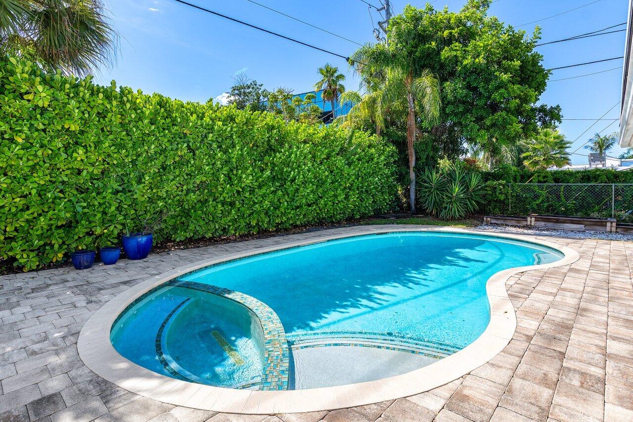 701 Buoy Road North Palm Beach, FL 33408 - Photo 38 of 52 a view of a swimming pool with a yard