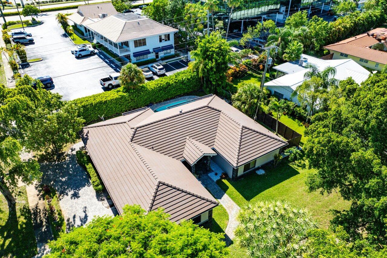 701 Buoy Road North Palm Beach, FL 33408 - Photo 40 of 52 a view of a house with a yard and a garden