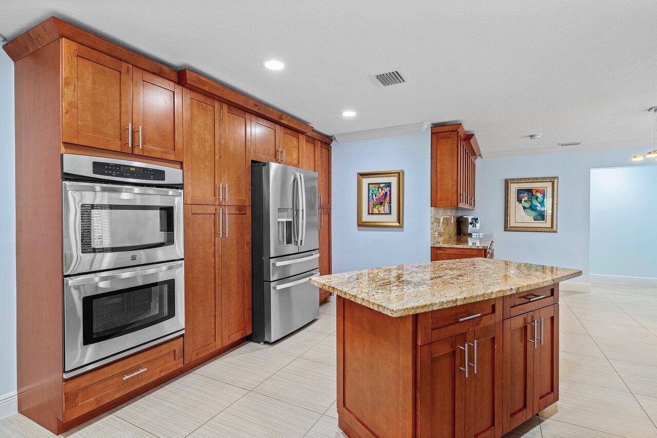 701 Buoy Road North Palm Beach, FL 33408 - Photo 9 of 52 a kitchen with stainless steel appliances granite countertop a refrigerator and a stove top oven