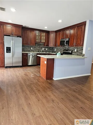 a kitchen with stainless steel appliances granite countertop a refrigerator stove a sink and dishwasher