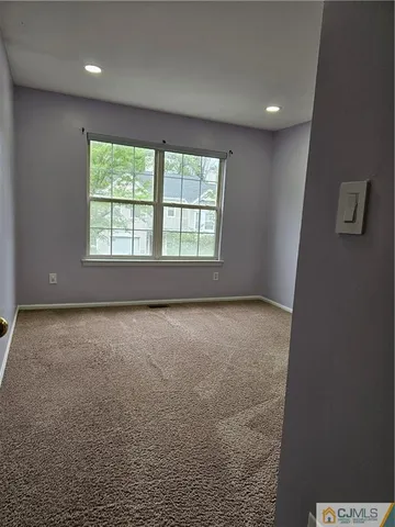an empty room with a empty space and windows