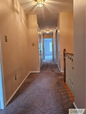 a view of a hallway with a room