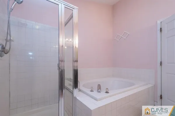 a bath tub sitting next to a shower