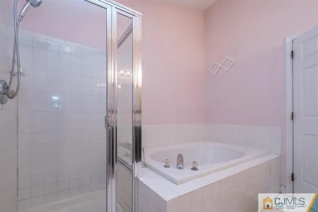 a bath tub sitting next to a shower