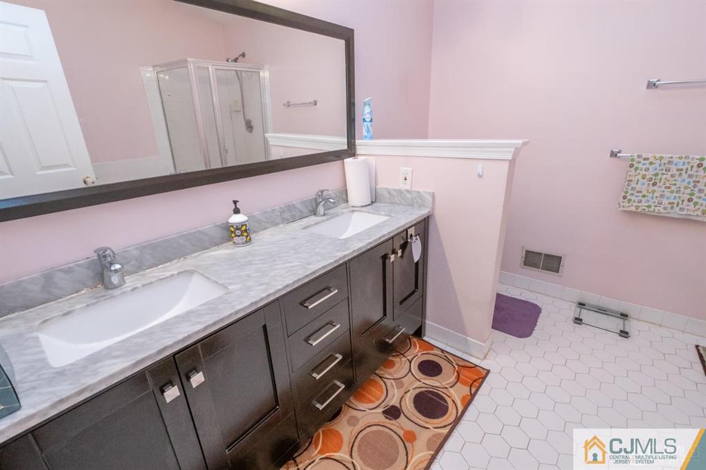 2403 Pheasant Run Monmouth Junction, NJ 08852 - Photo 22 of 36 a bathroom with a sink and a mirror
