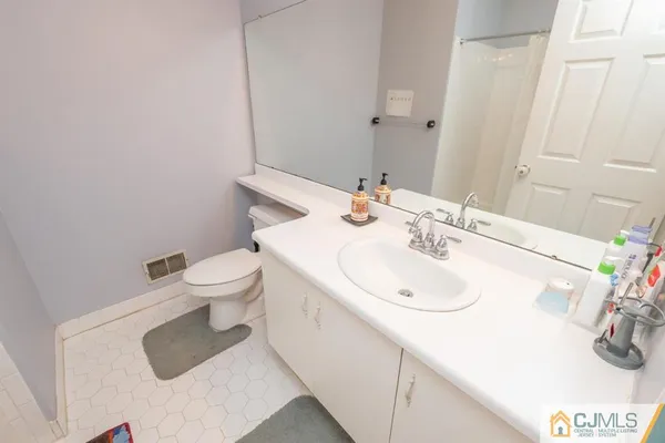 a bathroom with a sink toilet and vanity