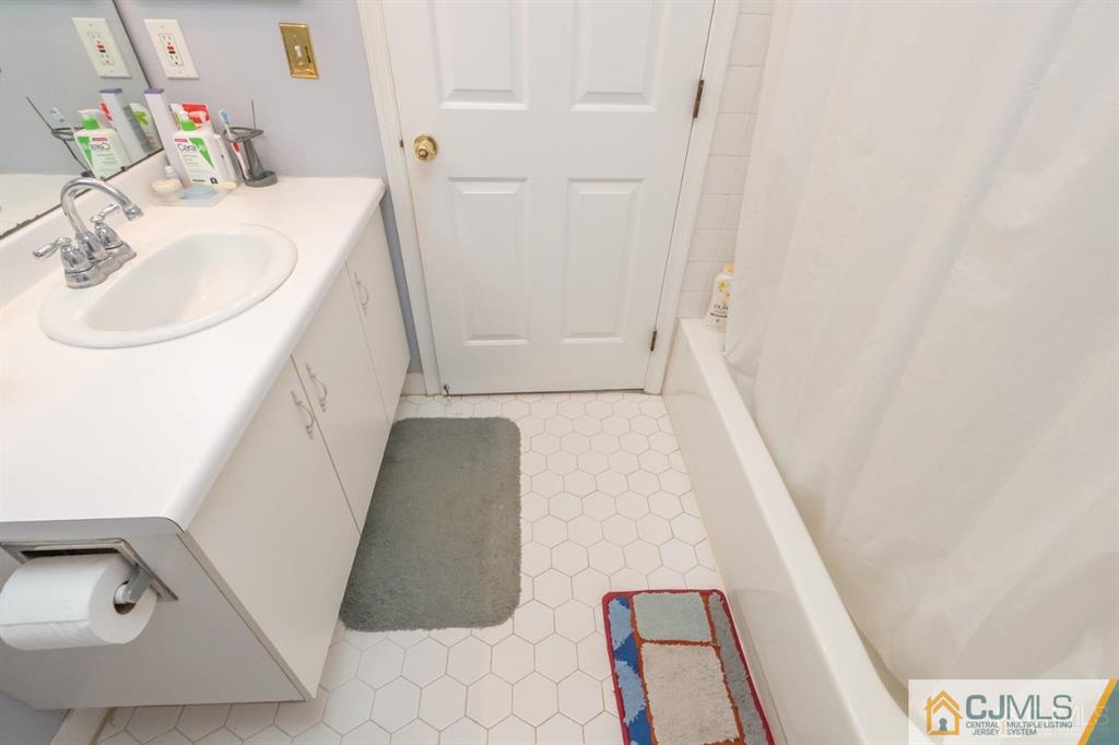 2403 Pheasant Run Monmouth Junction, NJ 08852 - Photo 24 of 36 a bathroom with a sink and a mirror