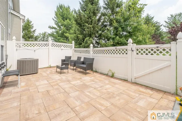 a view of a patio with table and chairs