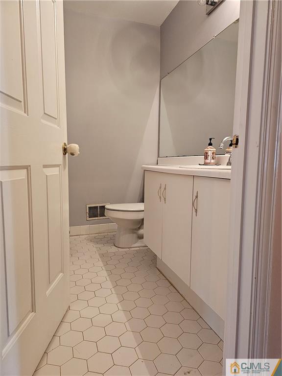 2403 Pheasant Run Monmouth Junction, NJ 08852 - Photo 27 of 36 a bathroom with a sink a toilet and a mirror