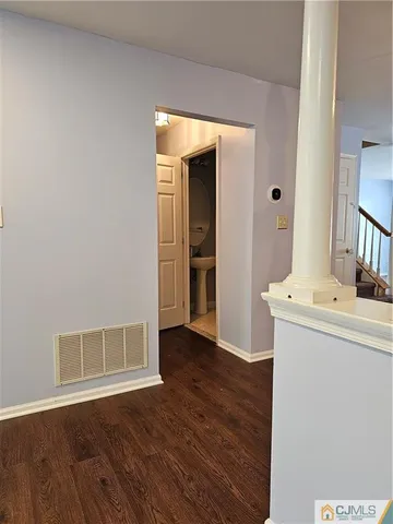 a view of a kitchen with wooden floor and electronic appliances