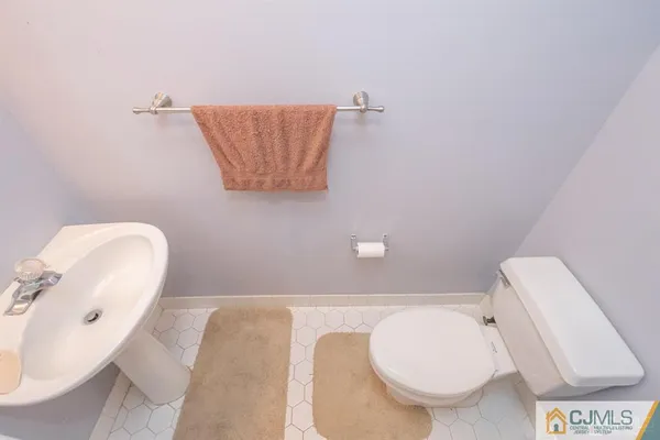a bathroom with a toilet and a mirror