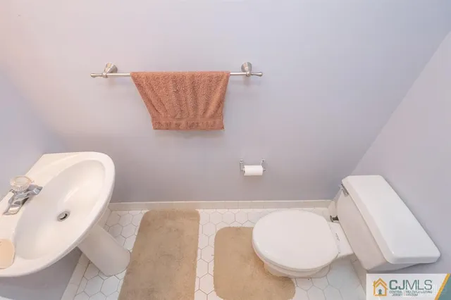 a bathroom with a toilet and a mirror