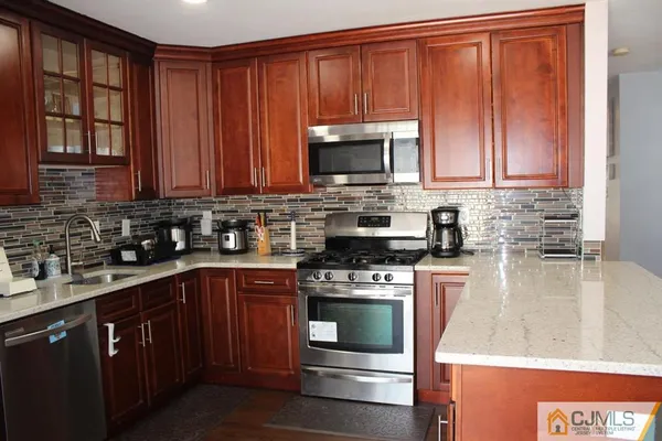 a kitchen with wooden cabinets and a stove top oven