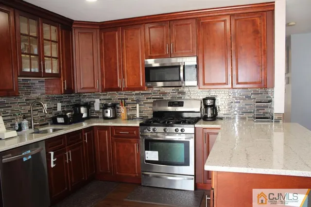 a kitchen with wooden cabinets and a stove top oven
