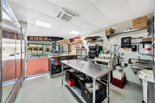 a kitchen with kitchen island a counter and a refrigerator