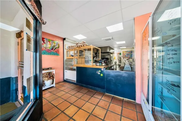 a kitchen with stainless steel appliances kitchen island granite countertop a refrigerator and a stove