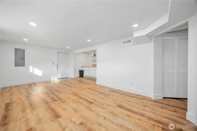 a view of empty room with wooden floor