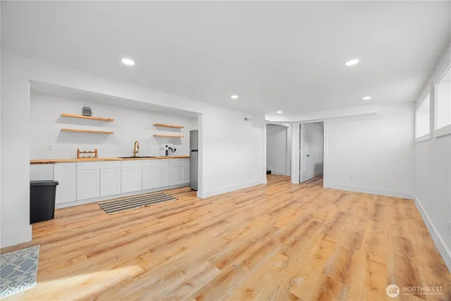 a view of a room with wooden floor and cabinet