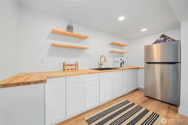 a kitchen with a refrigerator and a sink