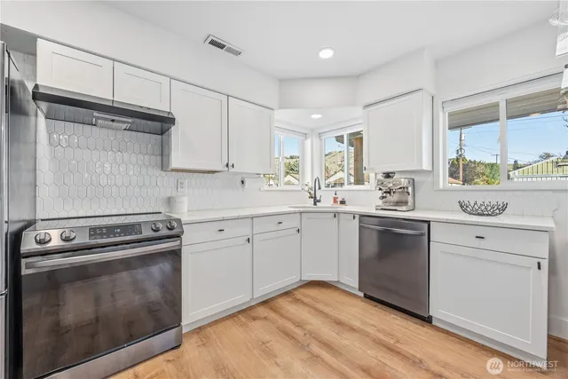 a kitchen with a stove oven and sink