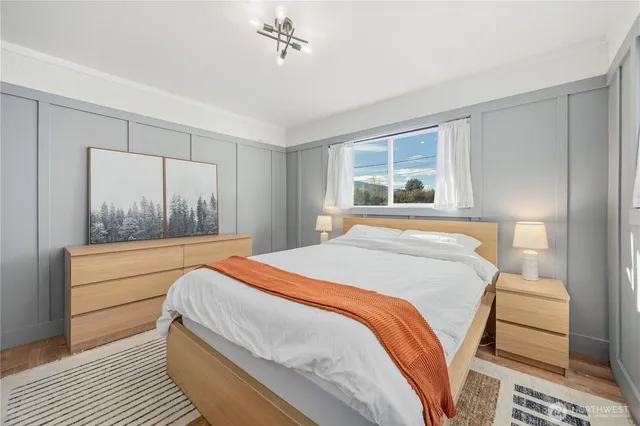 a bedroom with a large bed and a window