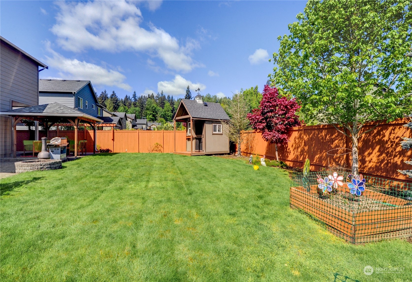 829 218th Street Southeast Bothell, WA 98021 - Photo 39 of 40 a front view of a house with a garden and outdoor seating