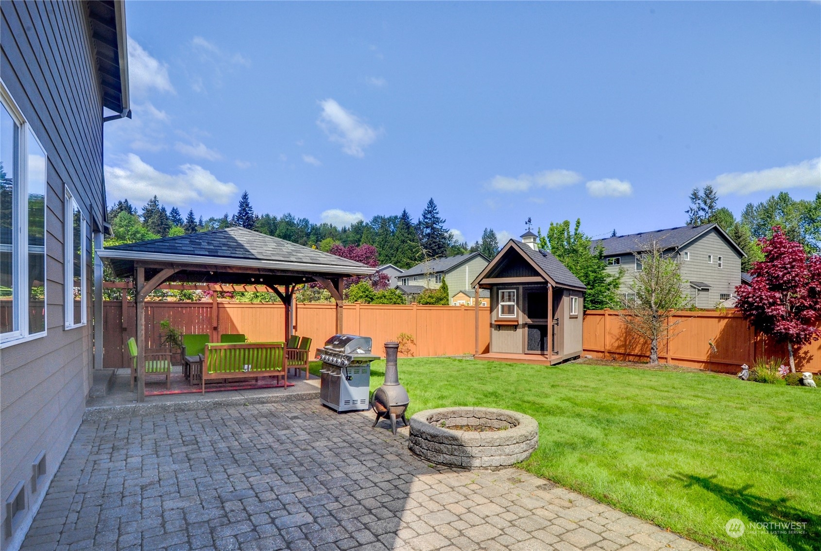 829 218th Street Southeast Bothell, WA 98021 - Photo 40 of 40 a view of a porch with a table and a fire pit