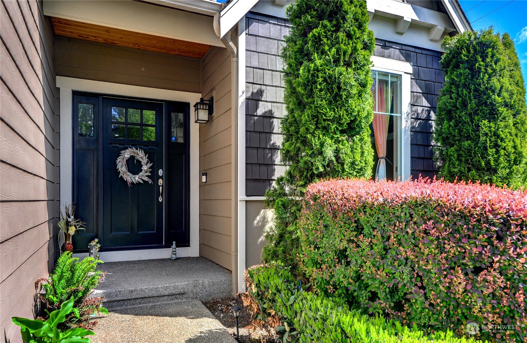 829 218th Street Southeast Bothell, WA 98021 - Photo 5 of 40 a view of a door of the house with potted plants