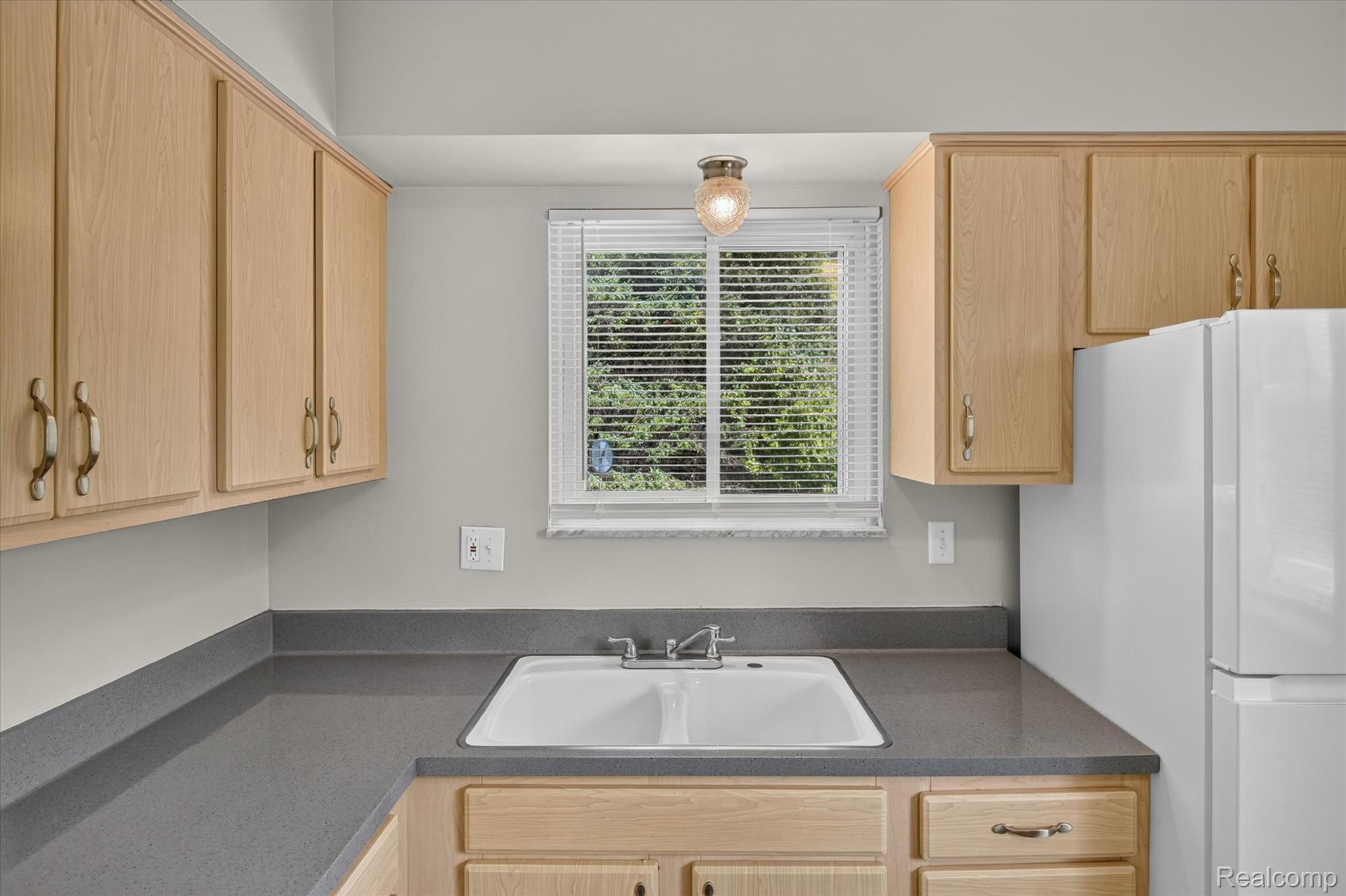 22000 Beck Road, Unit 101 Northville, MI 48167 - Photo 11 of 20 Light wood-finish cabinetry with brass hardware