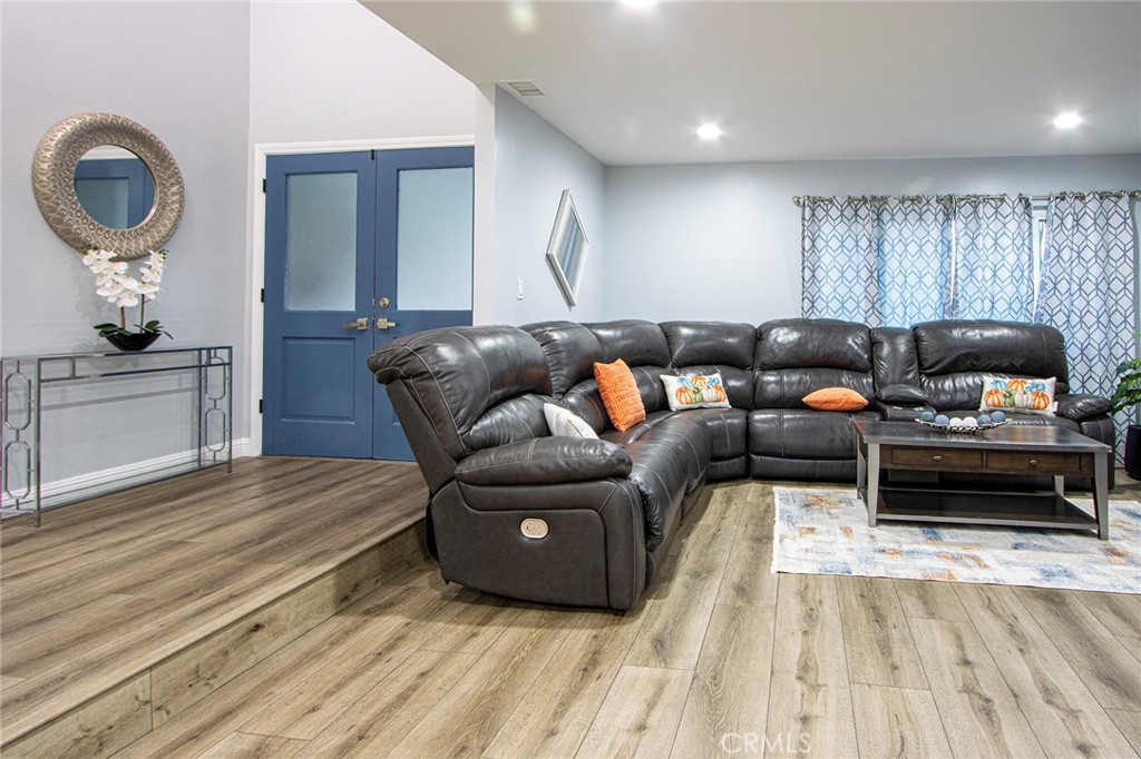 11503 Tropico Avenue Whittier, CA 90604 - Photo 2 of 5 a living room with furniture and a wooden floor