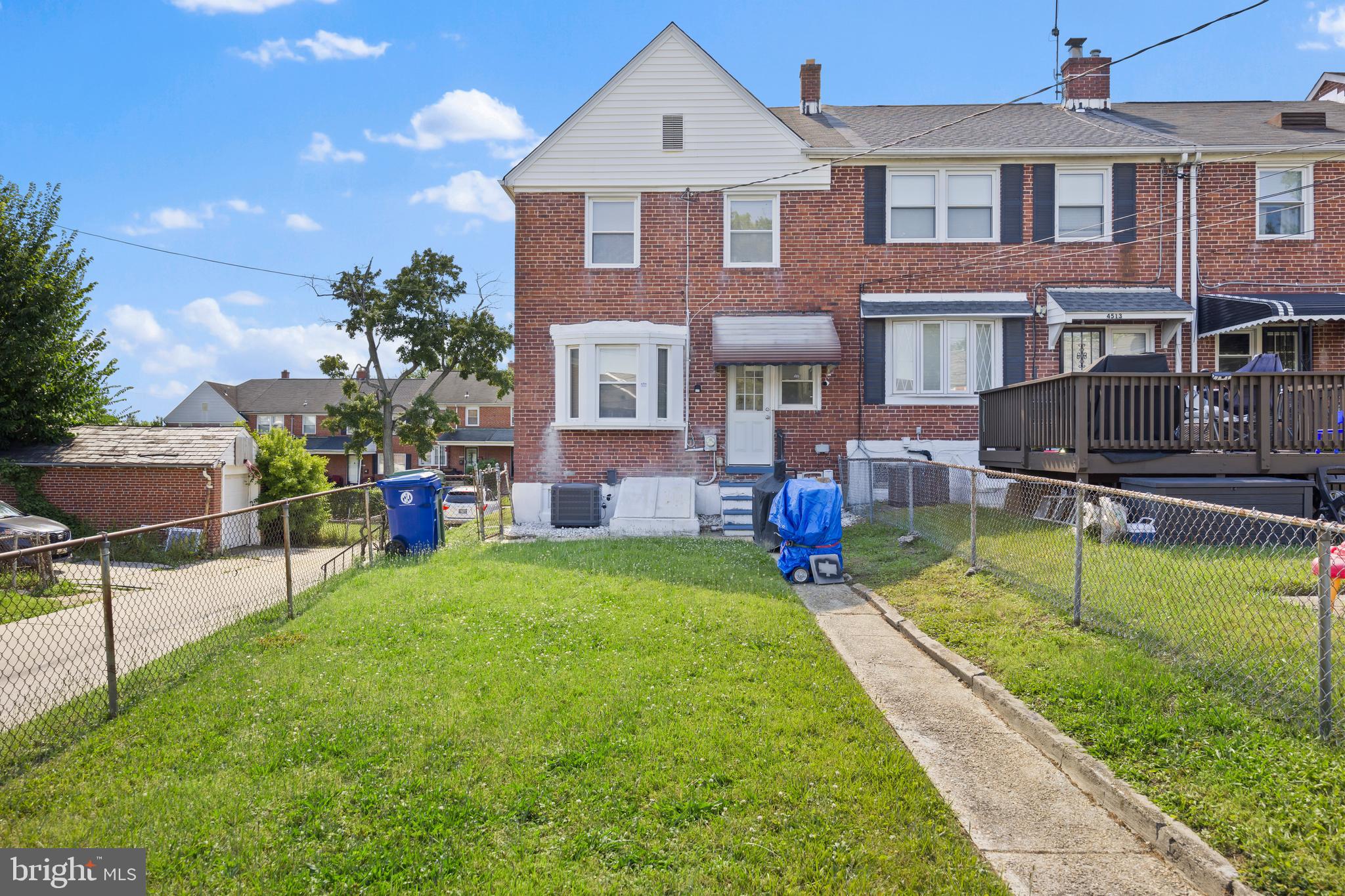 4511 Marble Hall Road Baltimore, MD 21239 - Photo 41 of 48 a front view of a house with a yard table and chairs