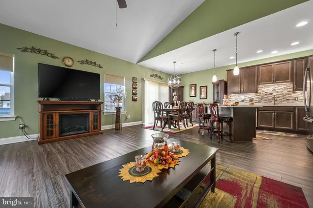 a living room with fireplace furniture and a flat screen tv