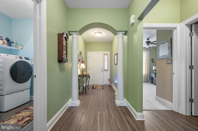 a view of a hallway view with wooden floor and staircase