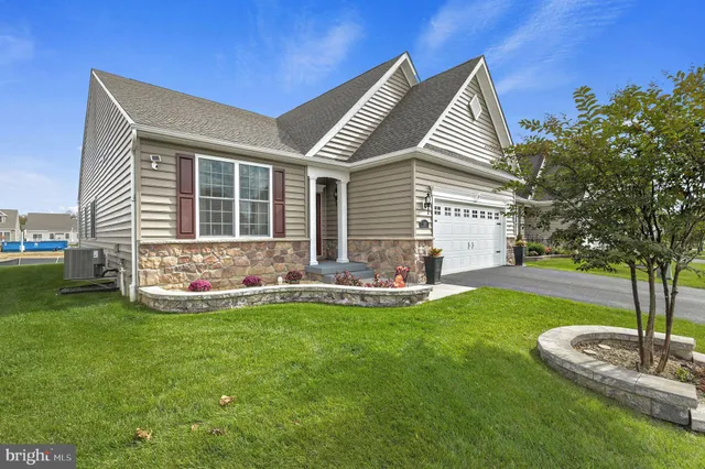 a front view of house with yard and outdoor seating
