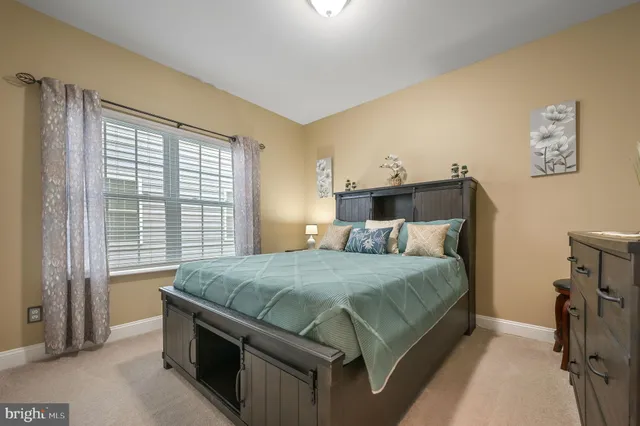 a bed sitting in a bedroom next to a window