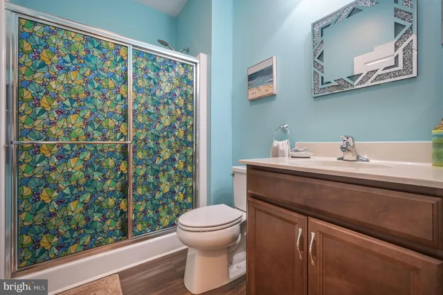 a bathroom with a sink toilet and a mirror