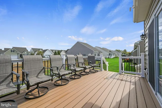 a view of a house with wooden deck