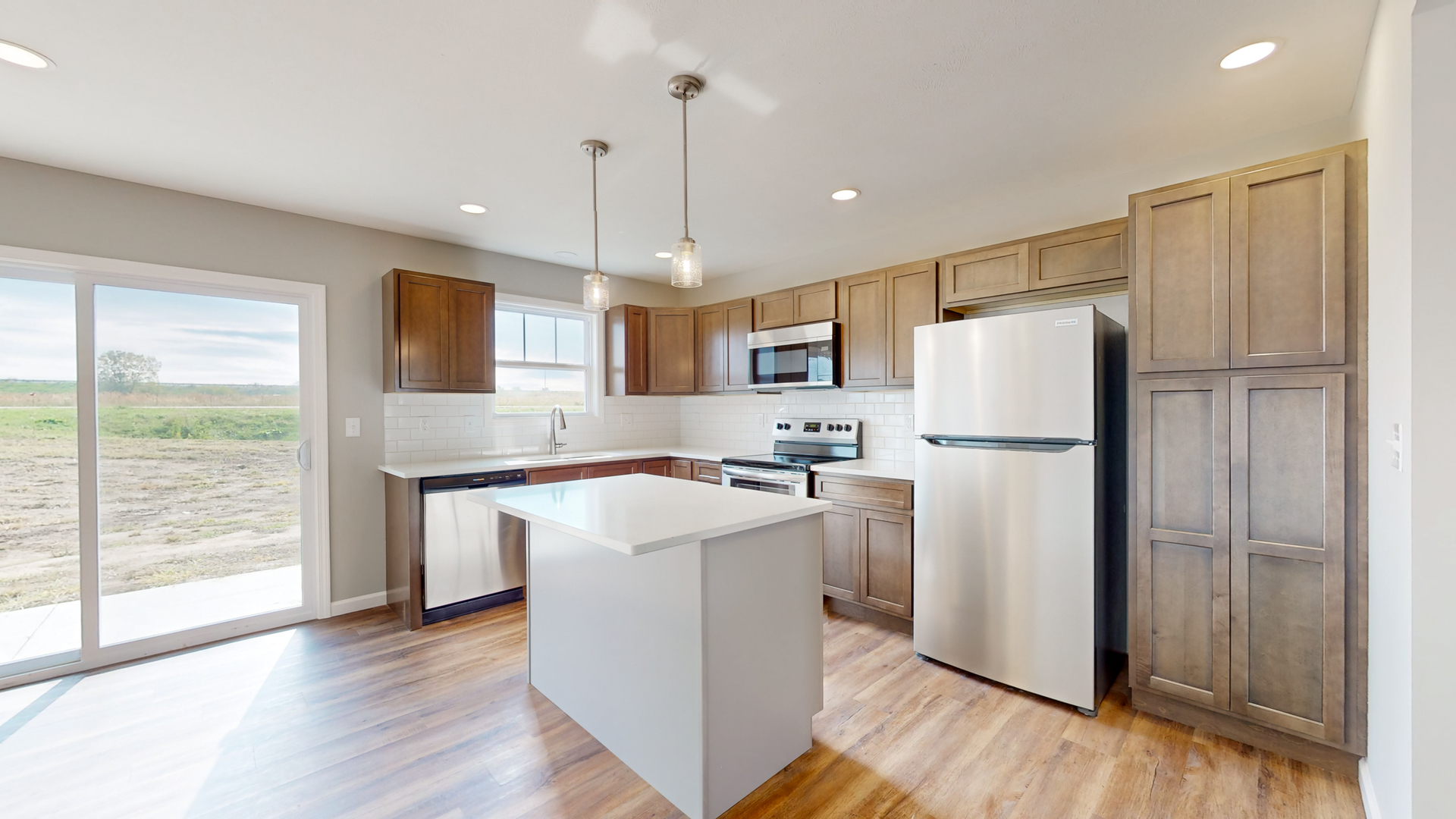 2 Megan Court Bloomington, IL 61705 - Photo 11 of 27 a kitchen with a refrigerator a sink and wooden floor