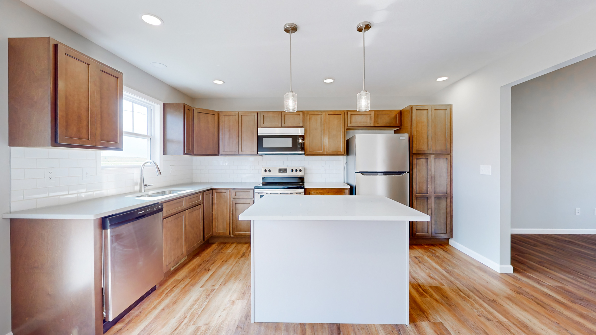 2 Megan Court Bloomington, IL 61705 - Photo 12 of 27 a kitchen with stainless steel appliances granite countertop a refrigerator a sink dishwasher a oven and a dining table with wooden floor