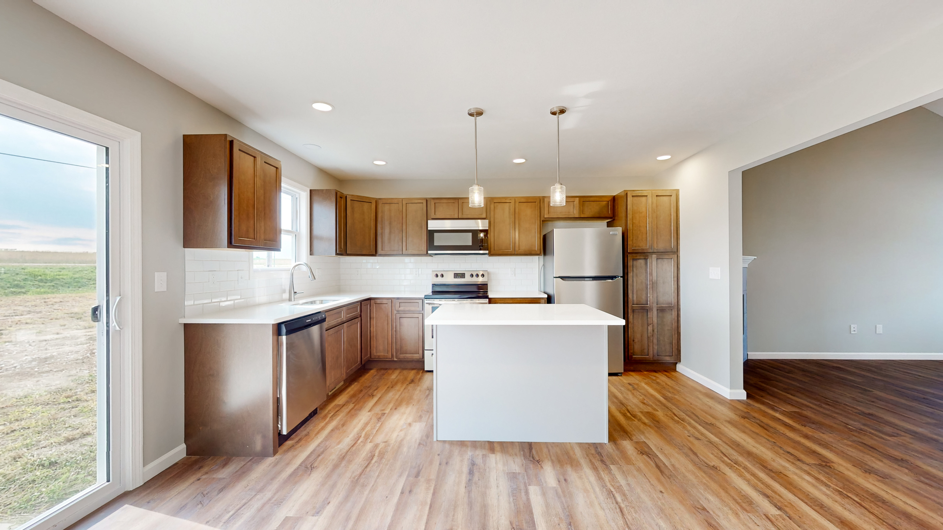 2 Megan Court Bloomington, IL 61705 - Photo 6 of 27 a kitchen with stainless steel appliances a refrigerator a sink dishwasher a s stove top oven a large island with wooden floor and cabinets