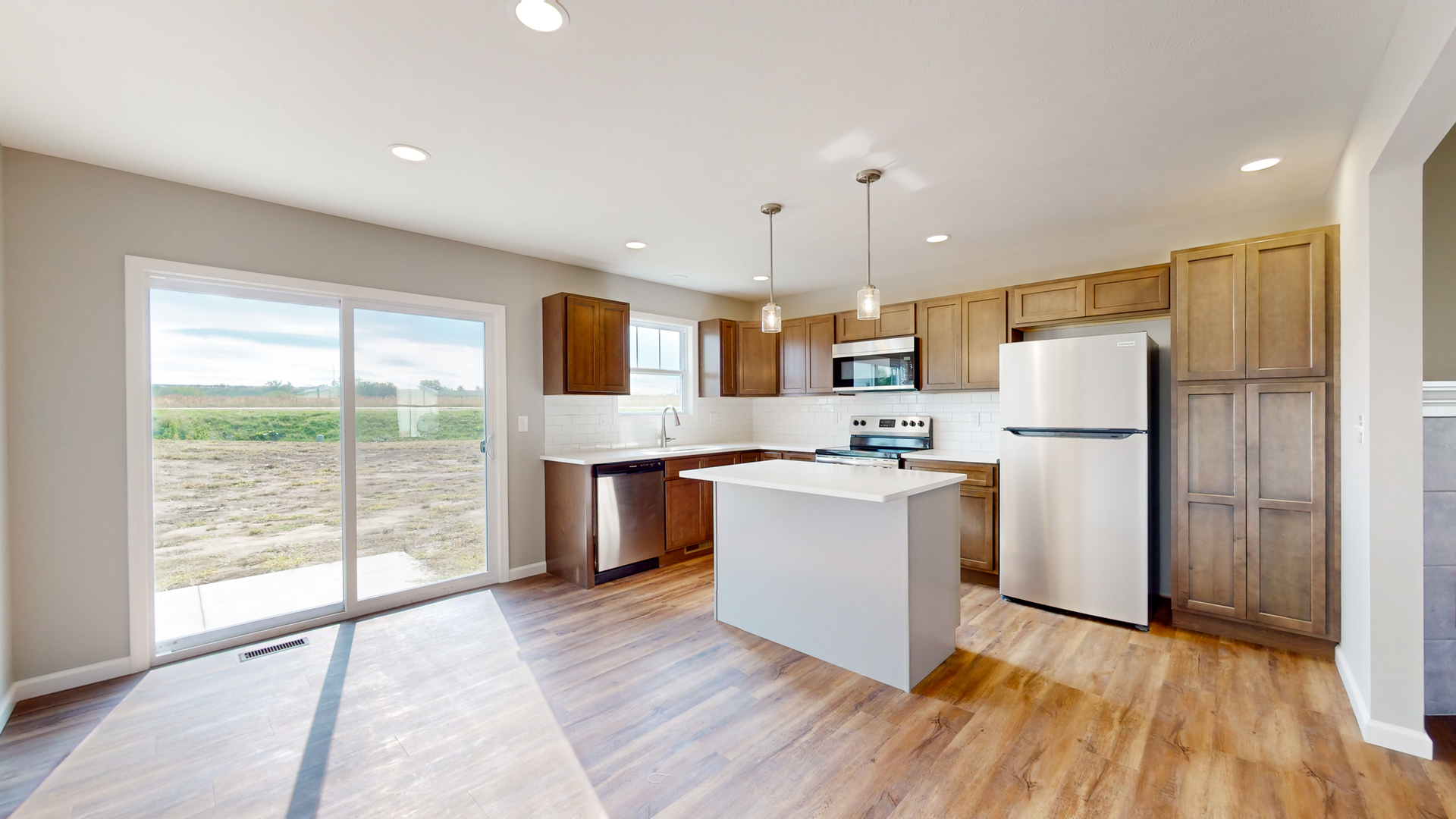 2 Megan Court Bloomington, IL 61705 - Photo 7 of 27 a kitchen with kitchen island wooden floors appliances and cabinets