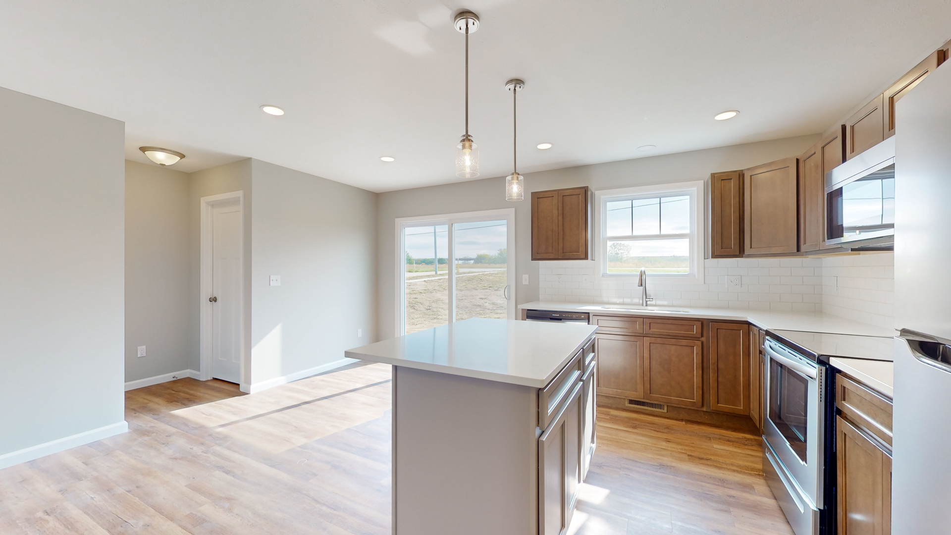 2 Megan Court Bloomington, IL 61705 - Photo 9 of 27 a kitchen with a sink a counter top space stainless steel appliances and a window