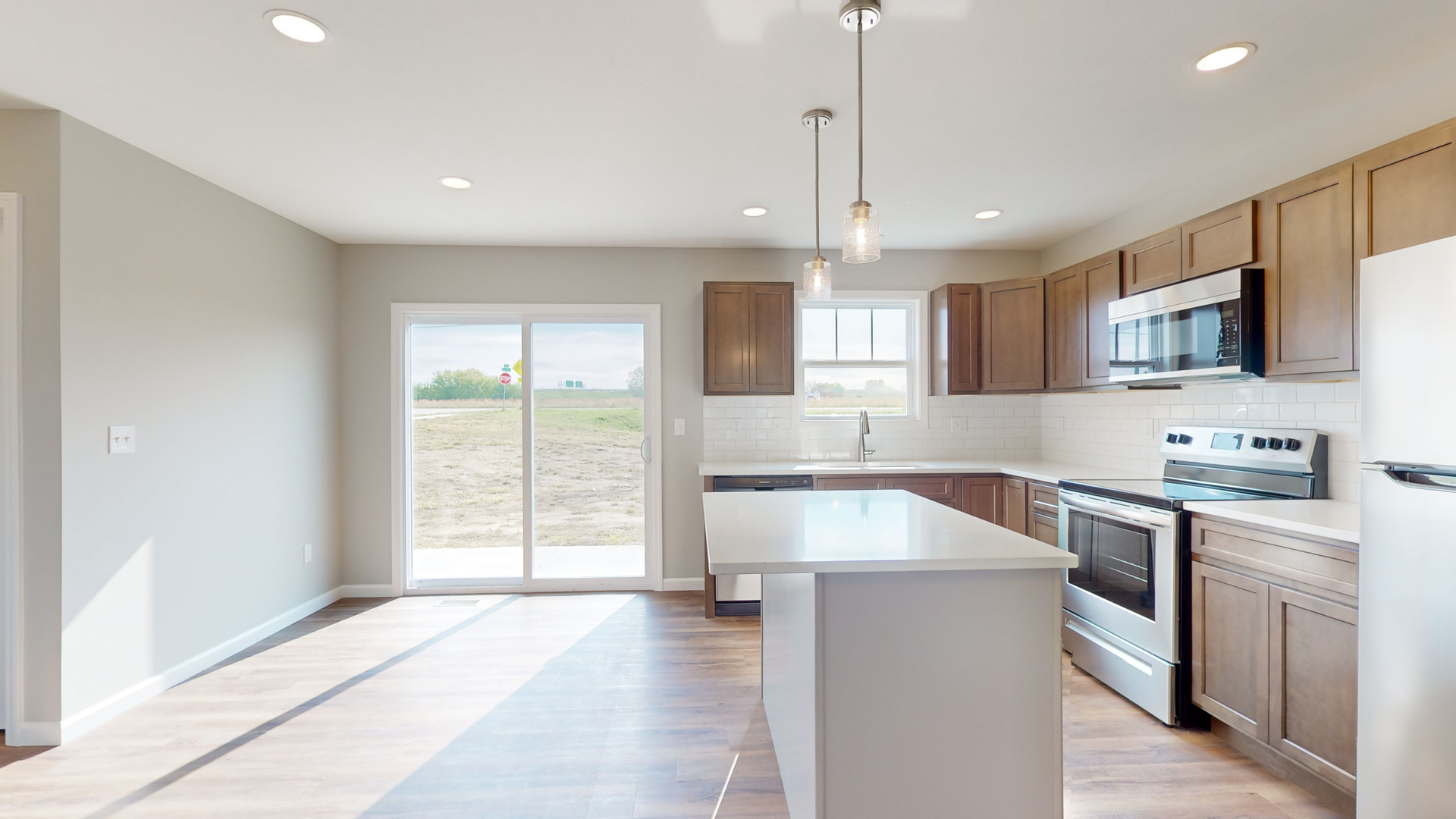 2 Megan Court Bloomington, IL 61705 - Photo 10 of 27 a kitchen with kitchen island granite countertop a stove top oven a sink a counter space and cabinets