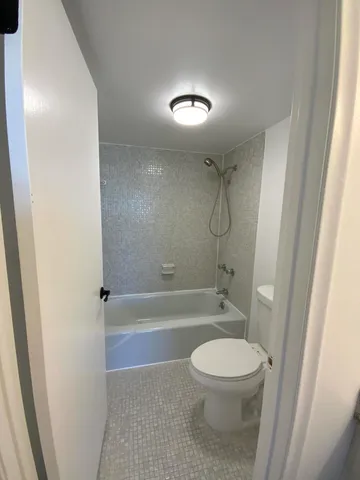 a bathroom with a toilet and a shower