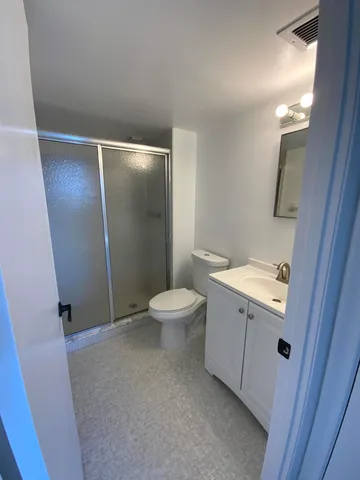 a bathroom with a sink and mirror with toilet