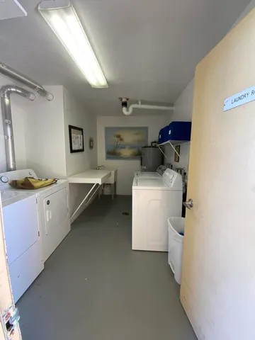 a living room with furniture and a lamp