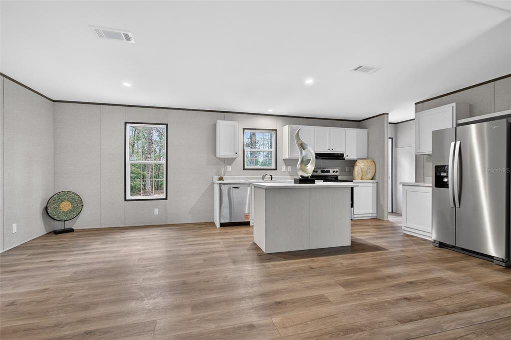 419 Lily Trail Interlachen, FL 32148 - Photo 12 of 78 a view of kitchen with microwave a refrigerator and windows